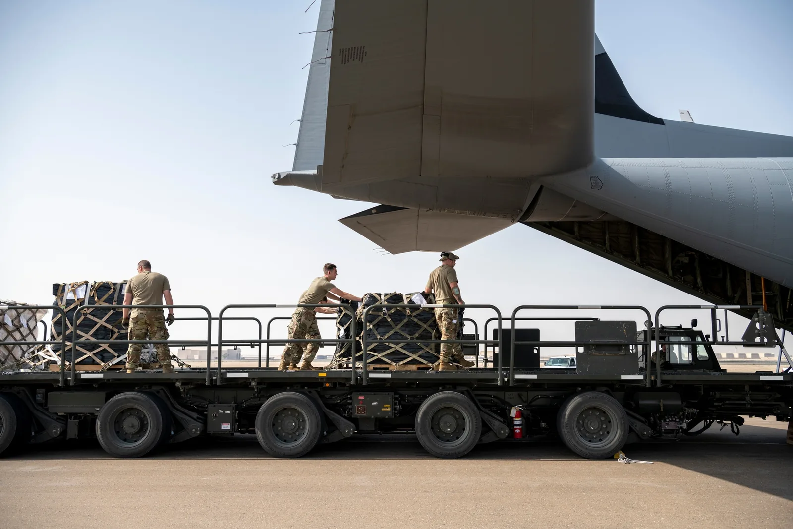 U.S. Air Force transportation specialists loading cargo into a C-130J Super Hercules