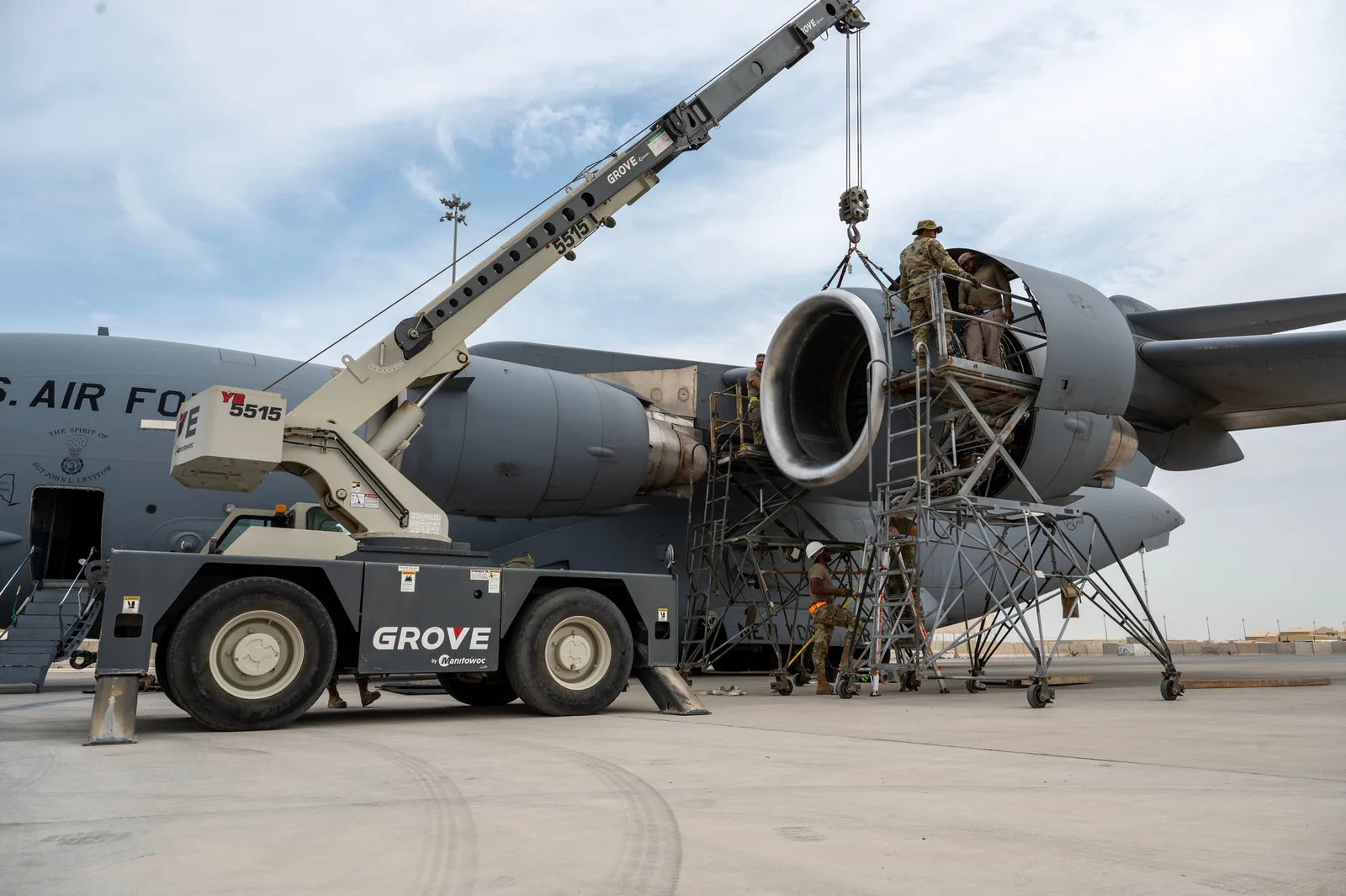 Illustrative U.S. Air Force maintenance team replacing a C-17 engine; not PMQ employees
