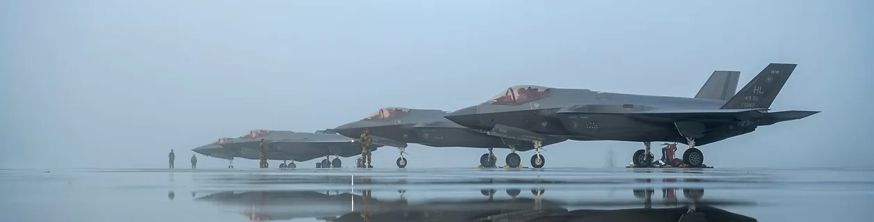 F-35A aircraft lined up on a misty flight line